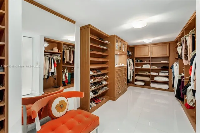 walk in closet with clothes and shoes