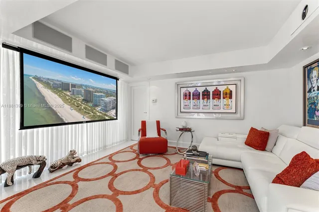 a living room with furniture kitchen view and a large window
