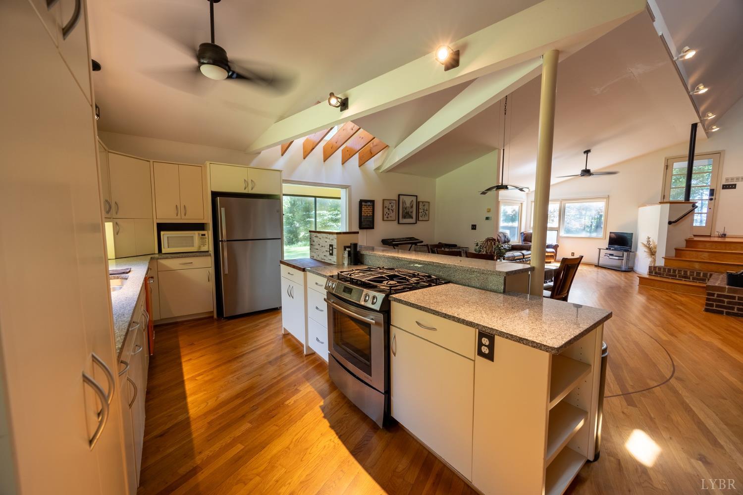 2246 Country Club Road Appomattox, VA 24522 - Photo 18 of 41 a kitchen with stainless steel appliances granite countertop a sink a stove and a refrigerator