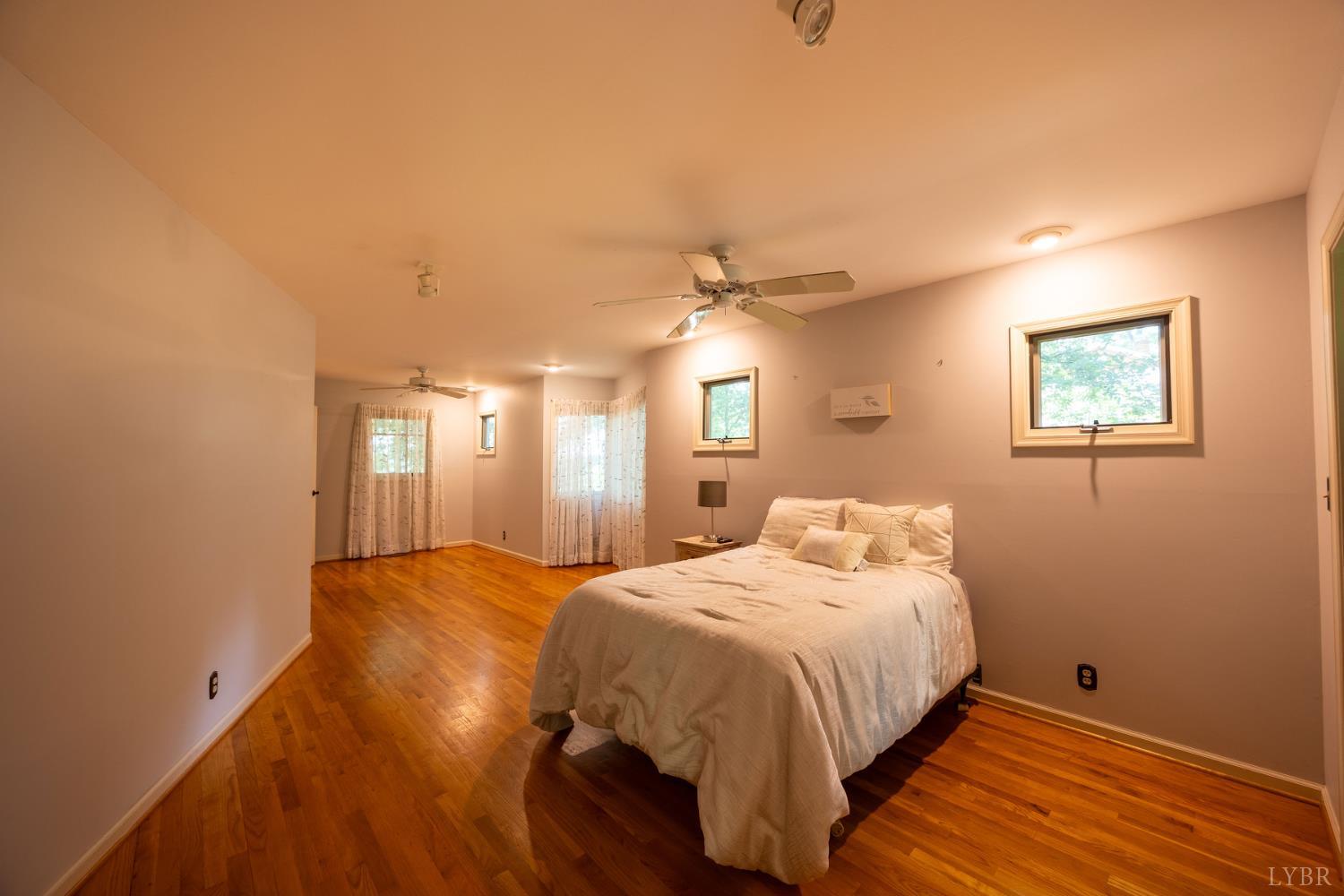 2246 Country Club Road Appomattox, VA 24522 - Photo 21 of 41 a bedroom with a bed and a chandelier