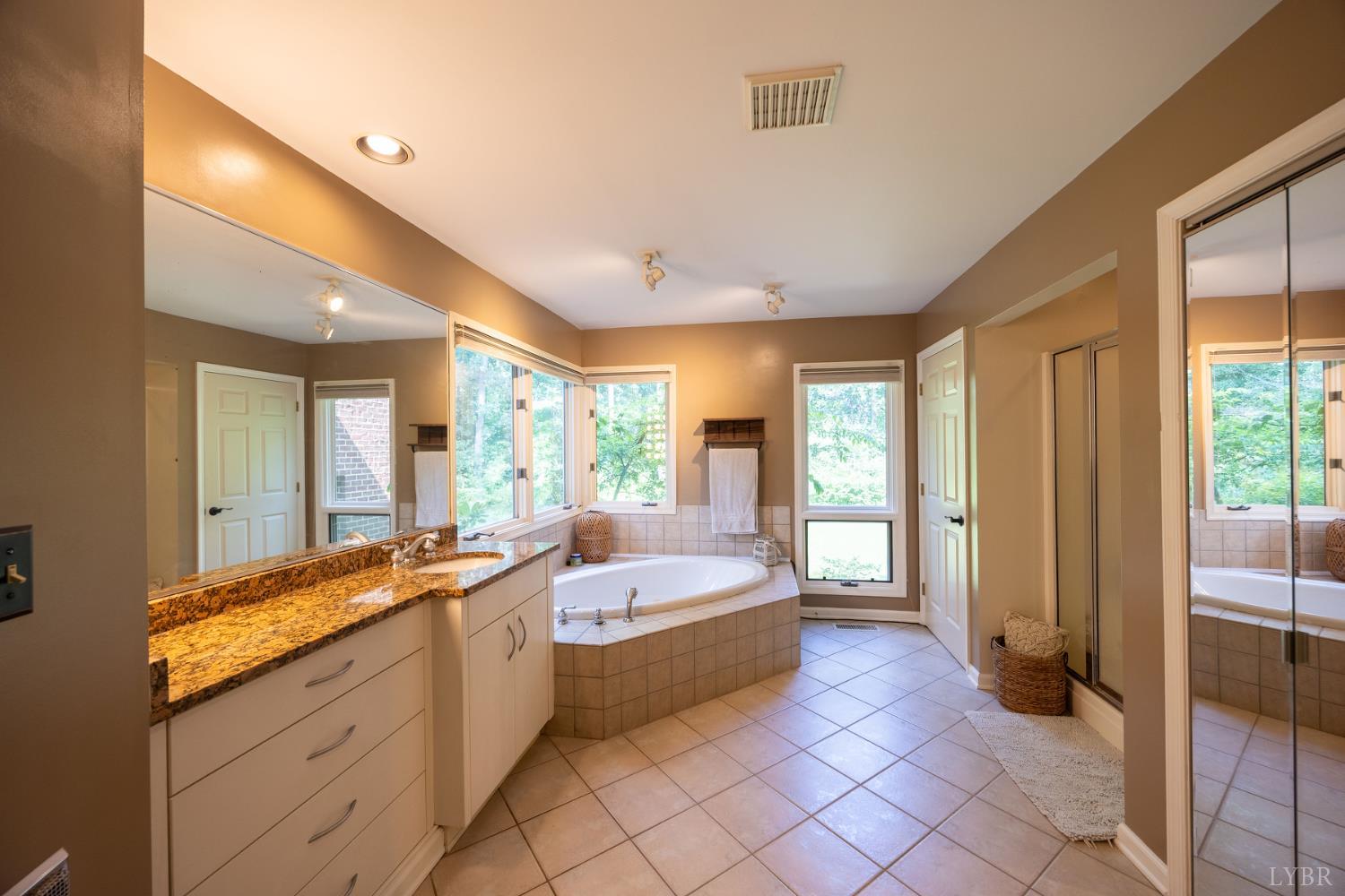 2246 Country Club Road Appomattox, VA 24522 - Photo 24 of 41 a spacious bathroom with a double vanity sink a mirror and a bathtub