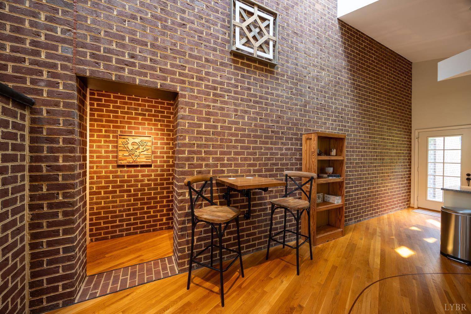 2246 Country Club Road Appomattox, VA 24522 - Photo 9 of 41 a view of a brick wall with chair and table in the room