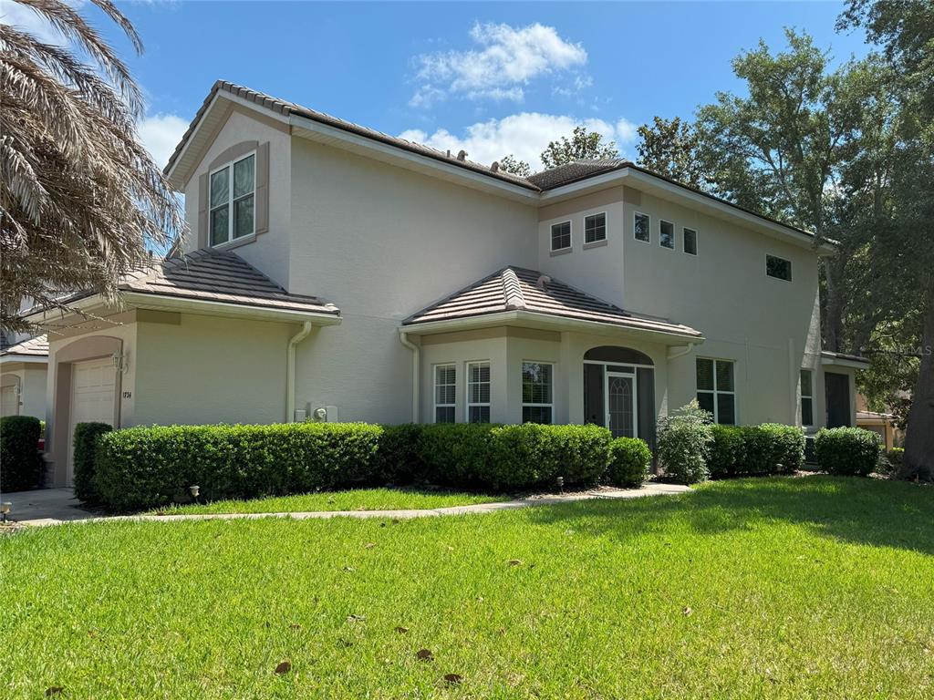 a front view of a house with garden