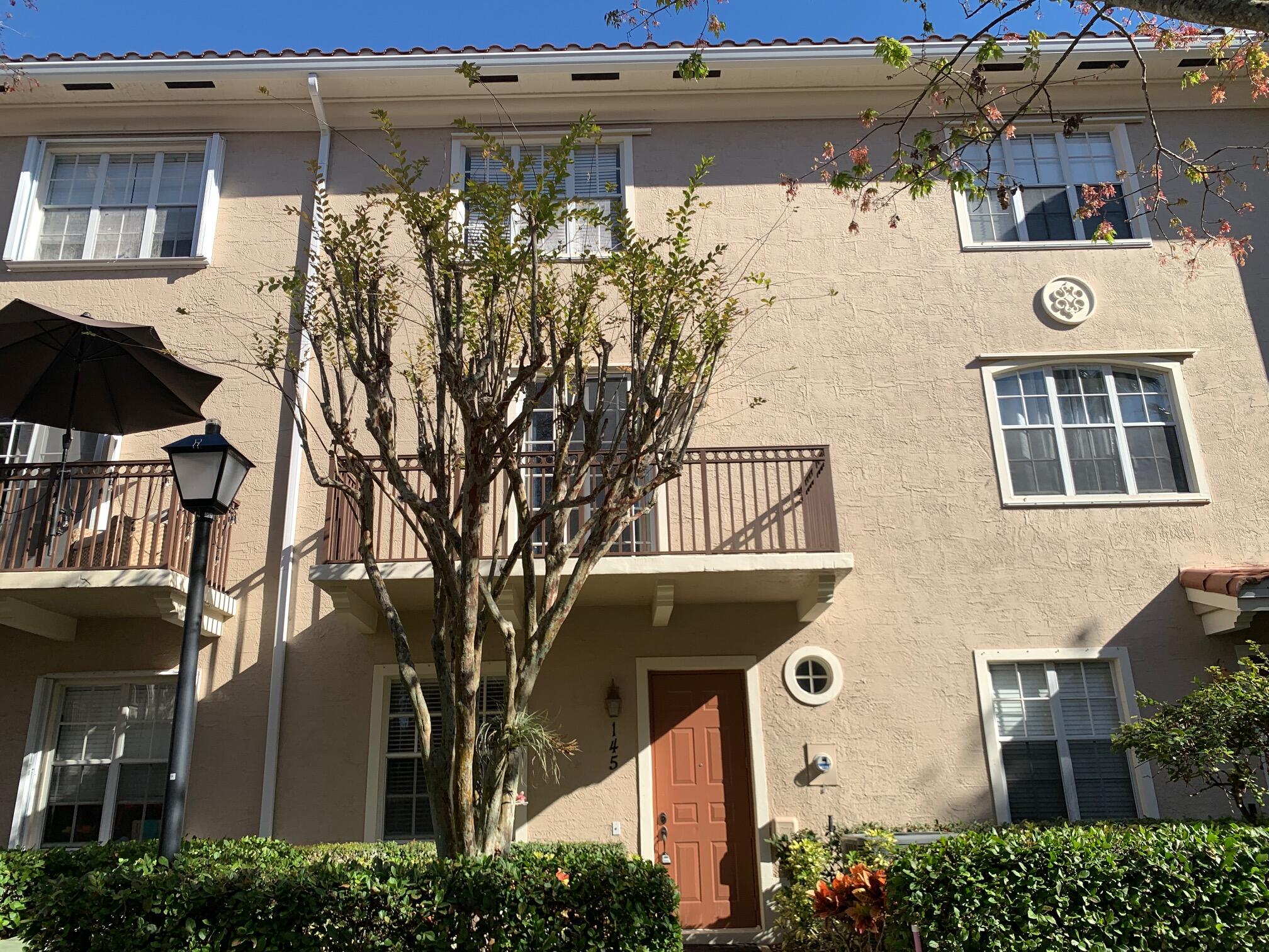 145 Morning Dew Circle Jupiter, FL 33458 - Photo 1 of 12 a front view of a house with a tree