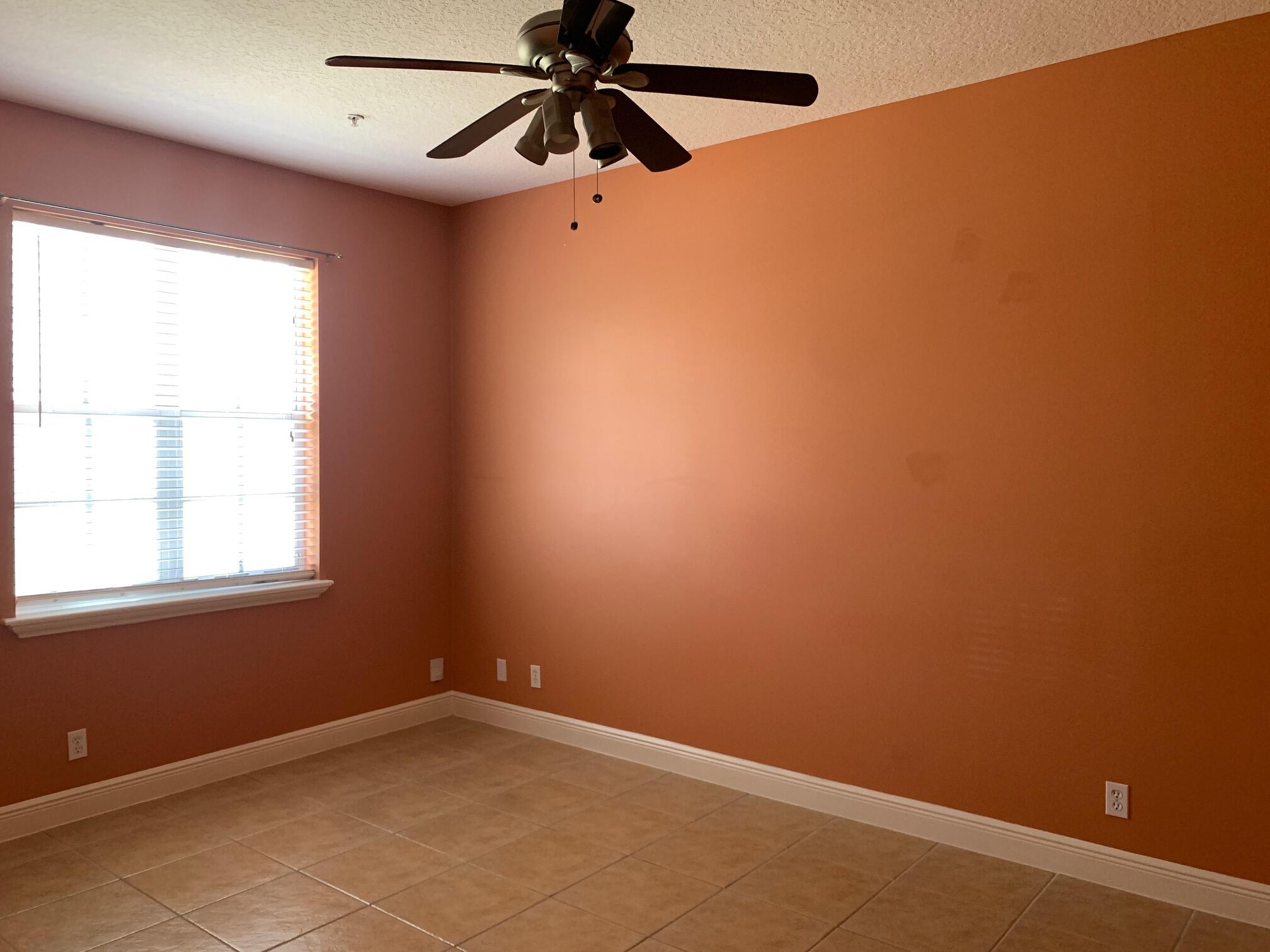 145 Morning Dew Circle Jupiter, FL 33458 - Photo 8 of 12 an empty room with a window and a fan