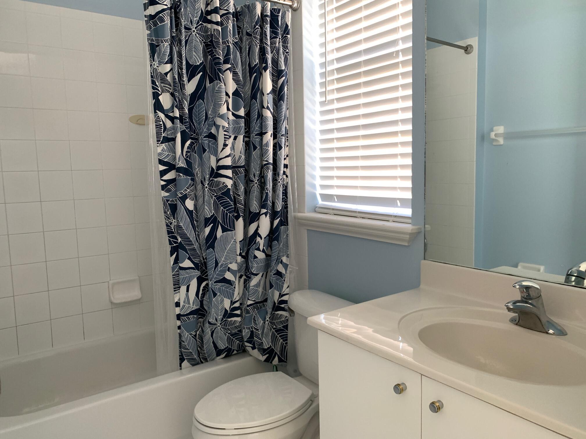 145 Morning Dew Circle Jupiter, FL 33458 - Photo 10 of 12 a bathroom with a sink toilet and shower