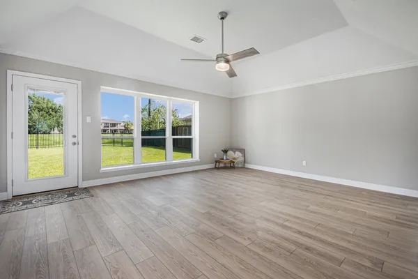a view of an empty room and wooden floor