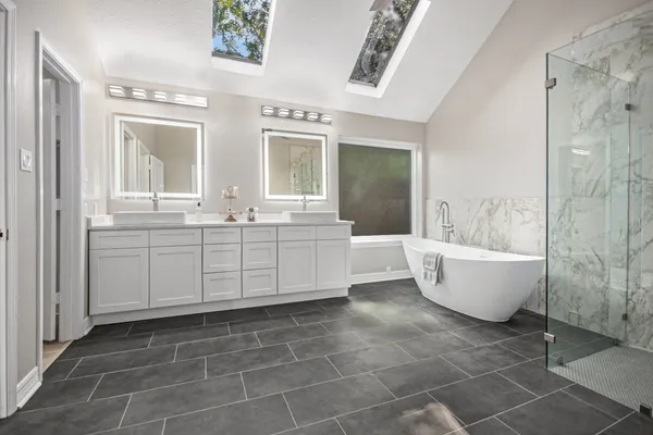 a spacious bathroom with a bathtub and shower