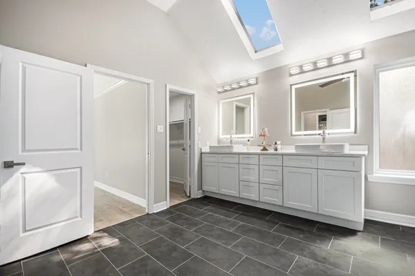 a bathroom with a bathtub and mirror