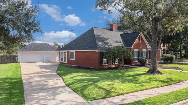 a front view of house with yard and green space