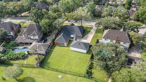 an aerial view of a house with a yard