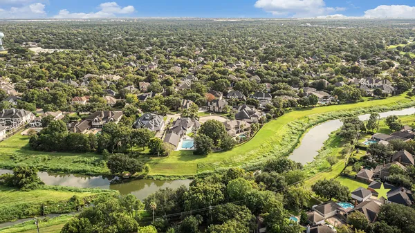 an aerial view of residential houses with outdoor space