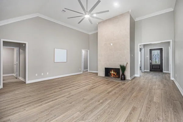 a view of a livingroom with wooden floor a fireplace and window