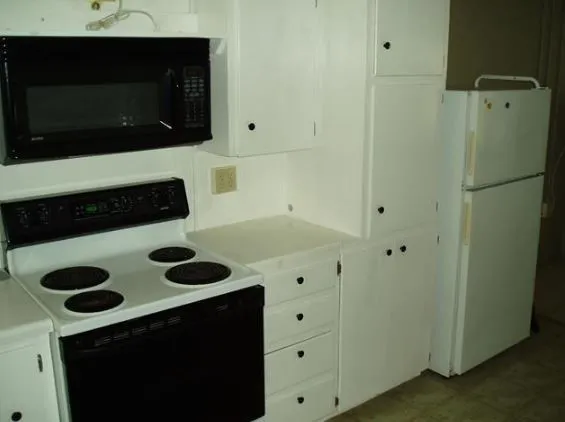 a kitchen with a refrigerator and a microwave