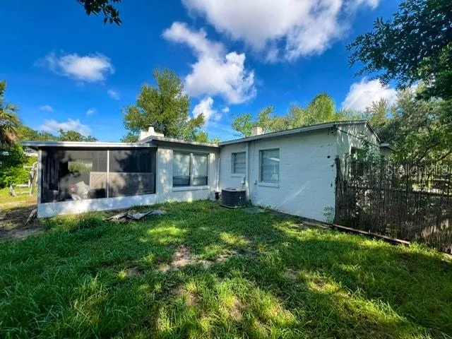 a backyard of a house with table and chairs