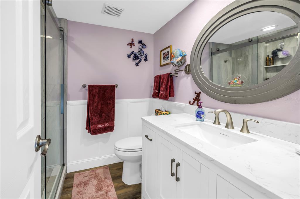4525 Cove Circle, Unit 102 St. Petersburg, FL 33708 - Photo 16 of 73 a bathroom with a toilet sink and mirror