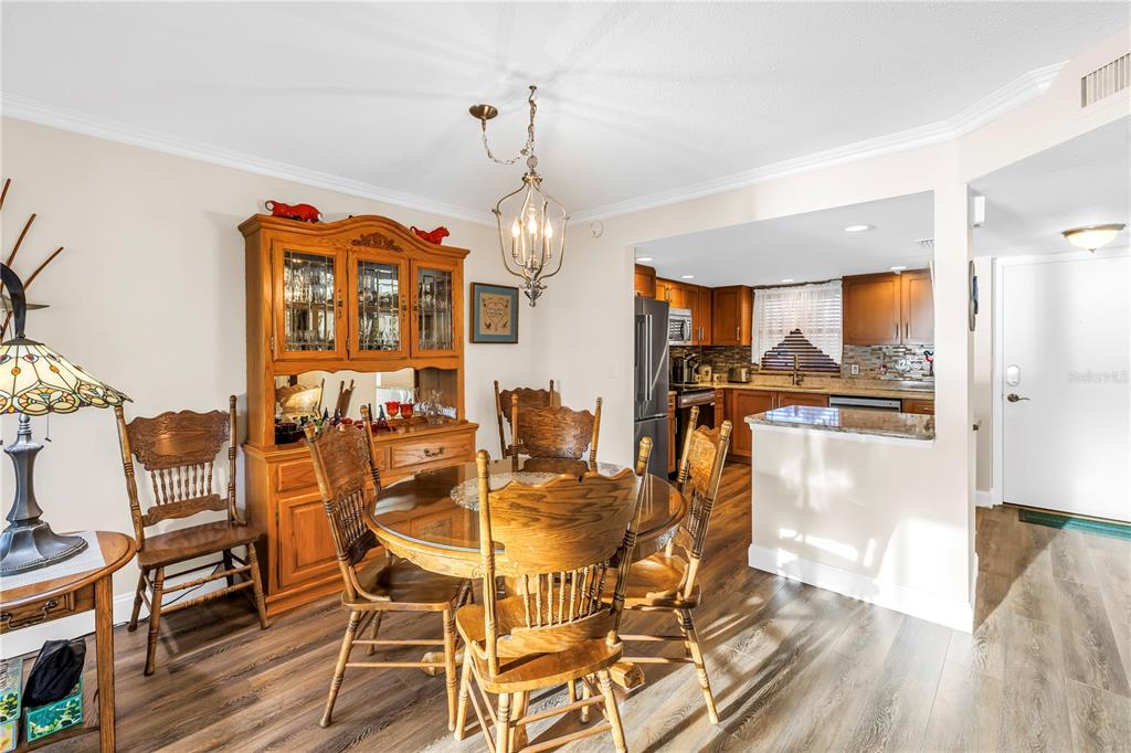 4525 Cove Circle, Unit 102 St. Petersburg, FL 33708 - Photo 24 of 73 a view of a dining room with furniture and wooden floor
