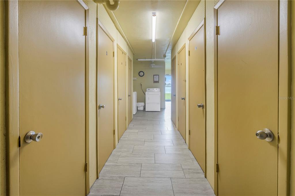 4525 Cove Circle, Unit 102 St. Petersburg, FL 33708 - Photo 46 of 73 a view of a hallway with a wooden door