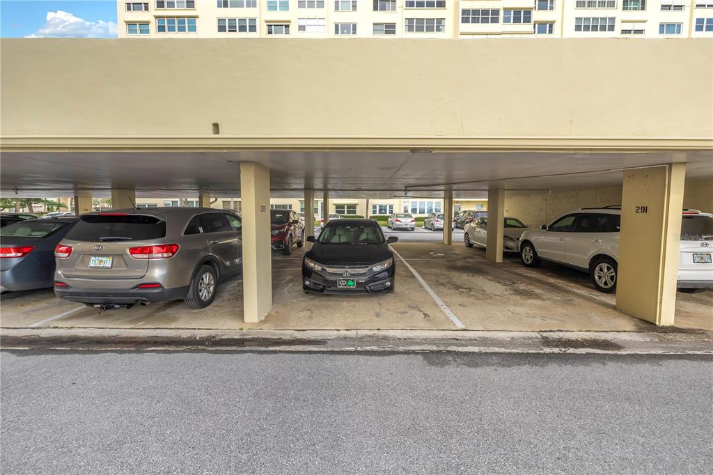 4525 Cove Circle, Unit 102 St. Petersburg, FL 33708 - Photo 51 of 73 a view of parking garage with cars