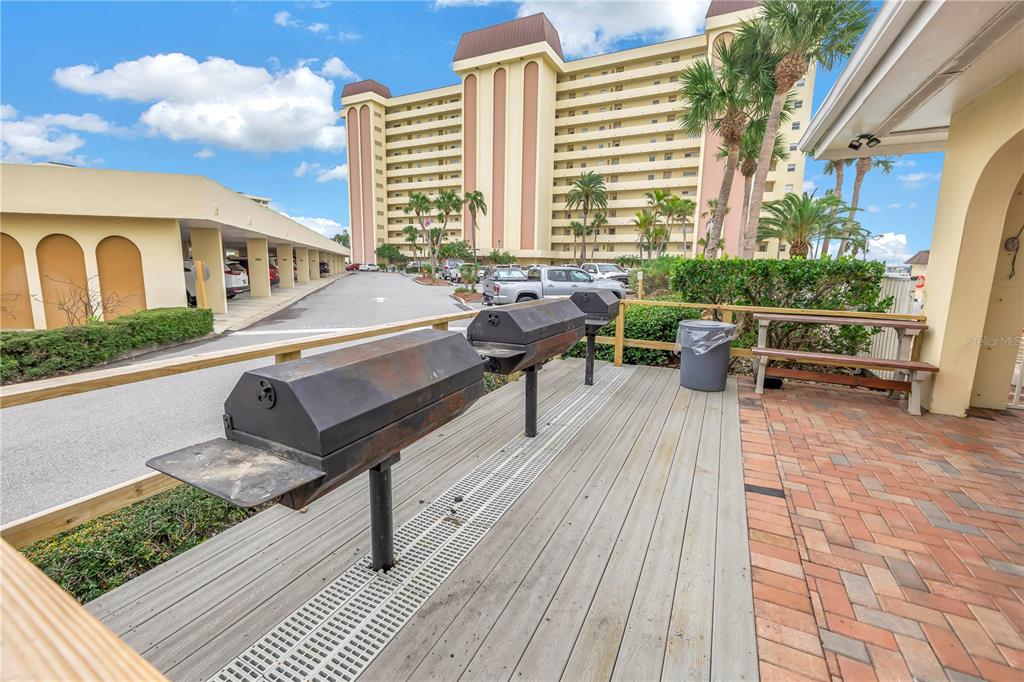 4525 Cove Circle, Unit 102 St. Petersburg, FL 33708 - Photo 65 of 73 a roof deck with outdoor seating and city view