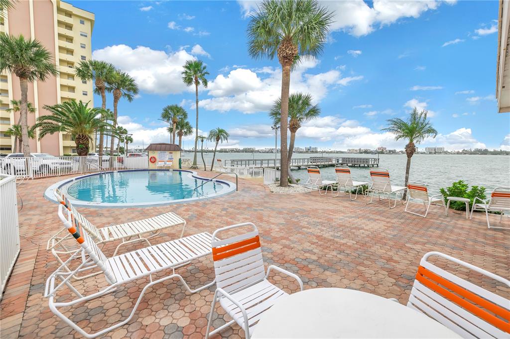 4525 Cove Circle, Unit 102 St. Petersburg, FL 33708 - Photo 67 of 73 a swimming pool with outdoor seating and city view