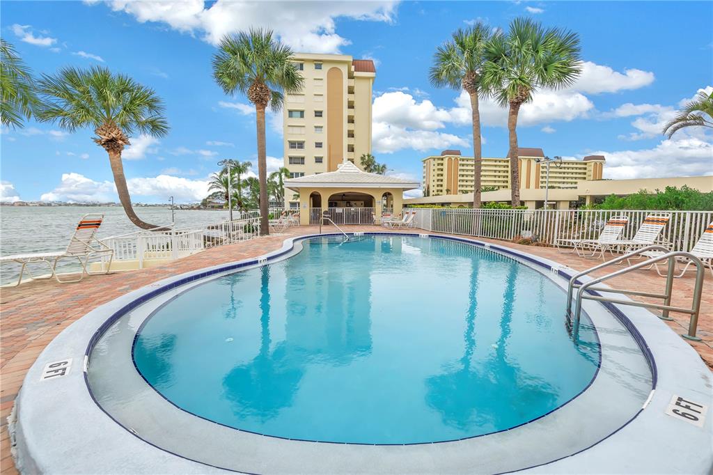 4525 Cove Circle, Unit 102 St. Petersburg, FL 33708 - Photo 68 of 73 a view of a swimming pool with outdoor seating