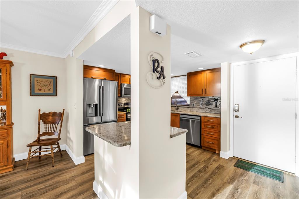 4525 Cove Circle, Unit 102 St. Petersburg, FL 33708 - Photo 9 of 73 a view of kitchen and dining room with wooden floor