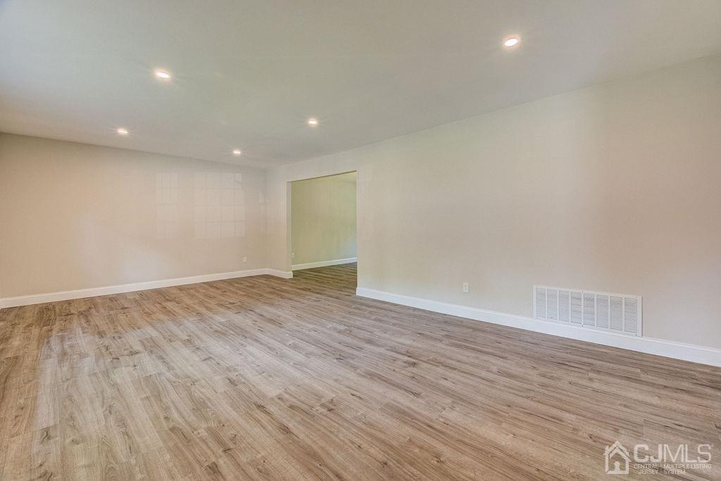 16 Oak Tree Road Monmouth Junction, NJ 08852 - Photo 11 of 29 an empty room with wooden floor and windows