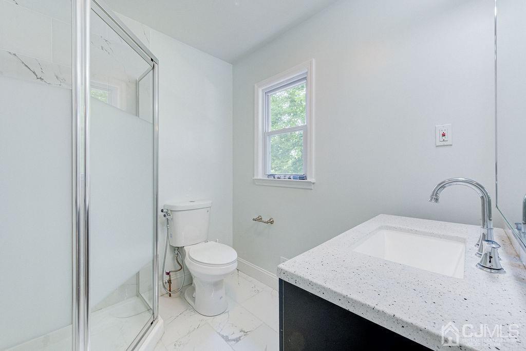 16 Oak Tree Road Monmouth Junction, NJ 08852 - Photo 14 of 29 a bathroom with a granite countertop sink a toilet and a window