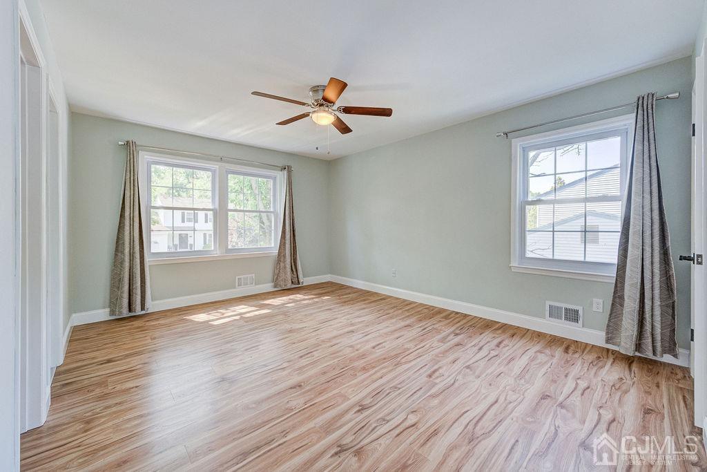 16 Oak Tree Road Monmouth Junction, NJ 08852 - Photo 17 of 29 wooden floor in an empty room with a window