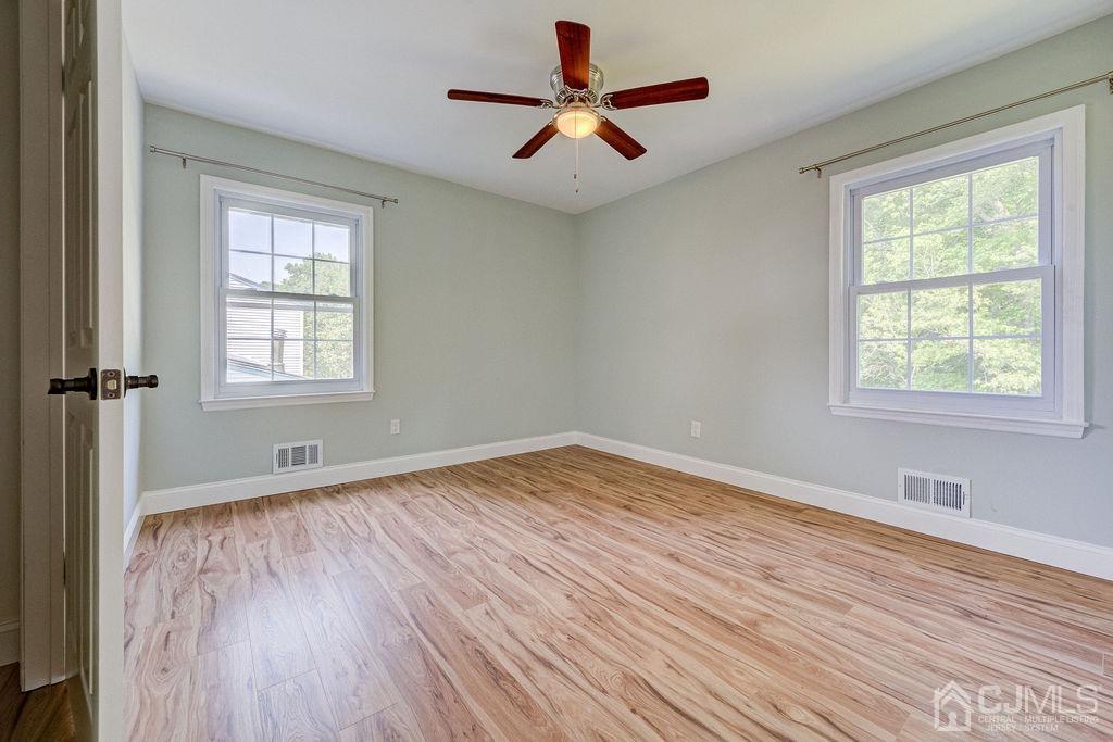 16 Oak Tree Road Monmouth Junction, NJ 08852 - Photo 18 of 29 a view of empty room with wooden floor and fan