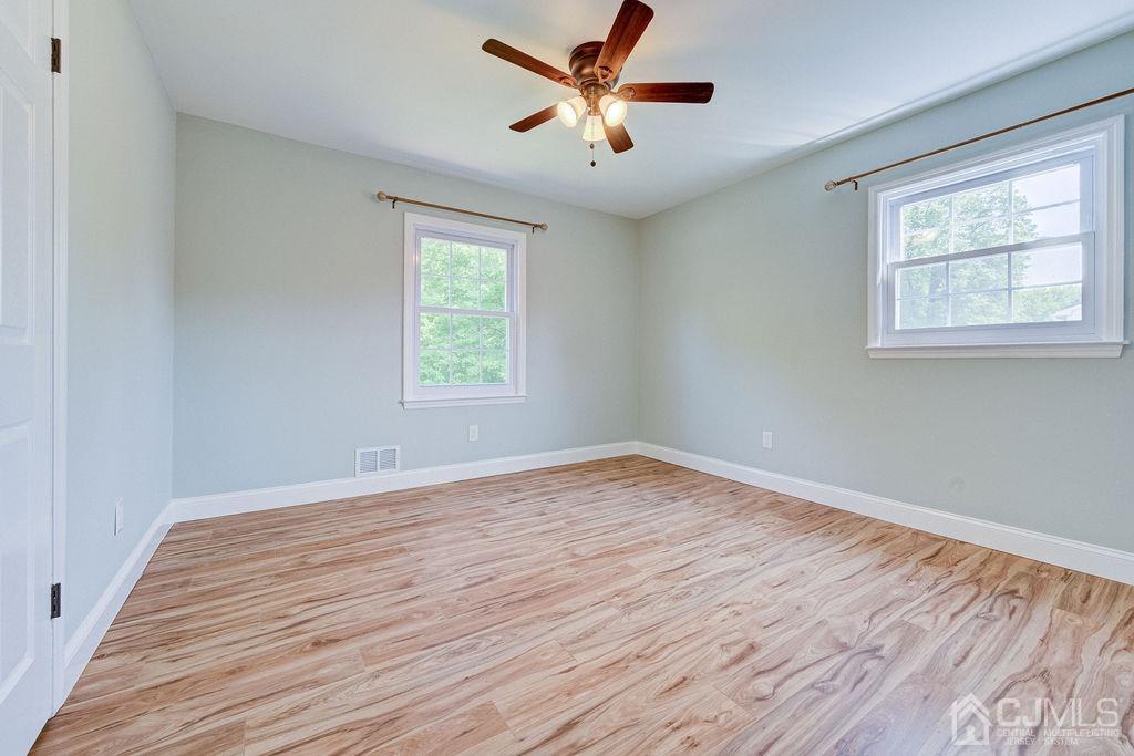 16 Oak Tree Road Monmouth Junction, NJ 08852 - Photo 20 of 29 a view of an empty room with wooden floor and a window