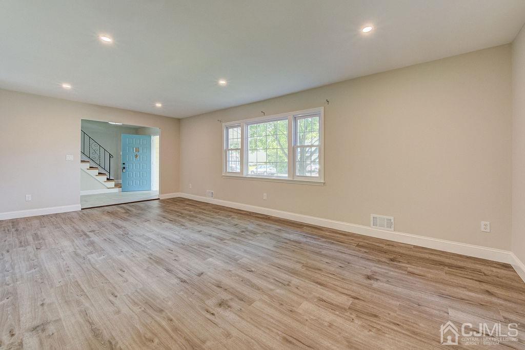 16 Oak Tree Road Monmouth Junction, NJ 08852 - Photo 8 of 29 an empty room with wooden floor and windows