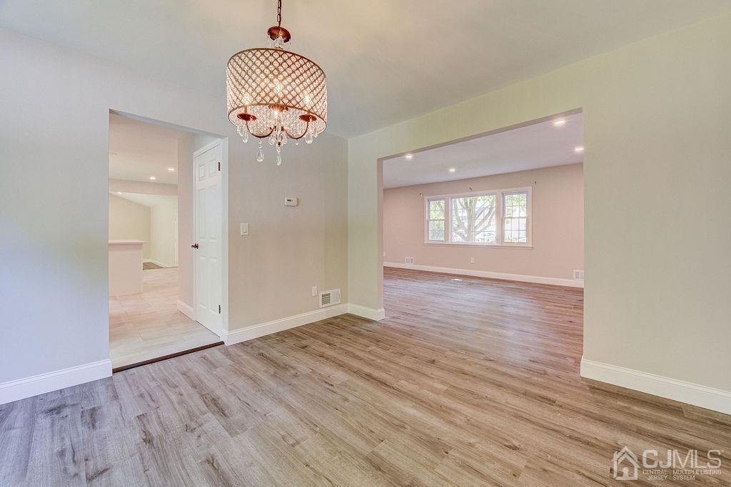 16 Oak Tree Road Monmouth Junction, NJ 08852 - Photo 9 of 29 an empty room with wooden floor and windows