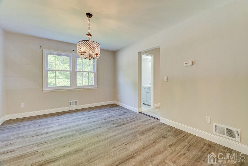 16 Oak Tree Road Monmouth Junction, NJ 08852 - Photo 10 of 29 a view of an empty room with wooden floor and a window