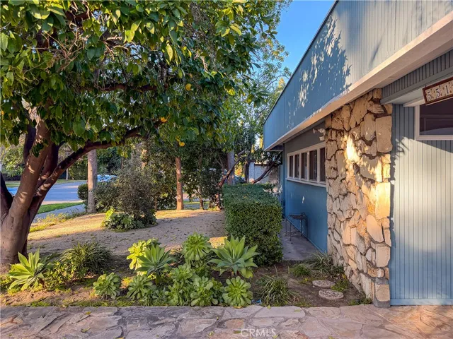 a view of a patio with a table chairs and backyard