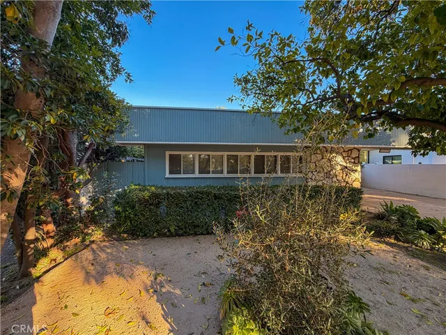 a view of a patio with a table chairs and a backyard