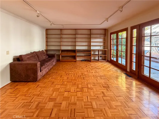 a view of an empty room with cabinet and a window