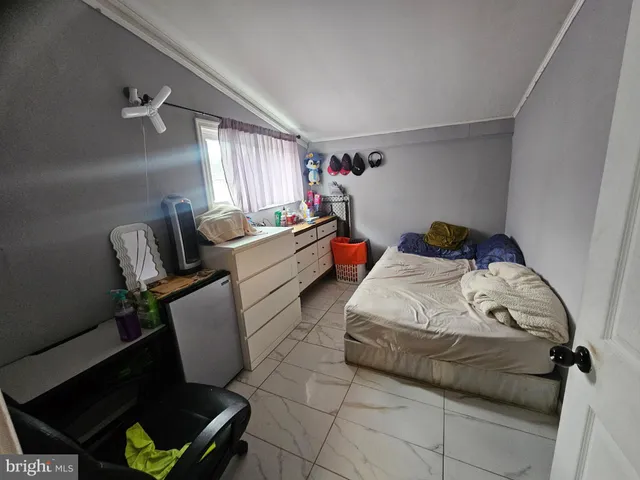 a bed room with a bed and a chair