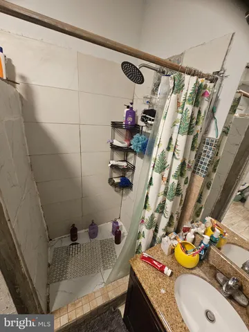 a bathroom with a sink and a shower curtain