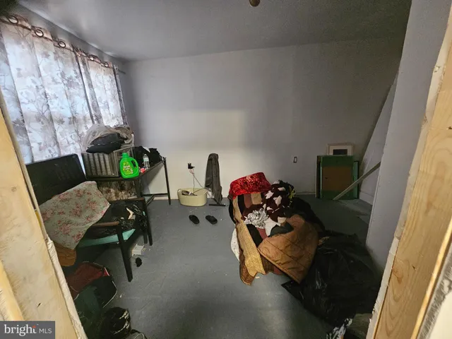 a living room with furniture a flat screen tv and a bookshelf