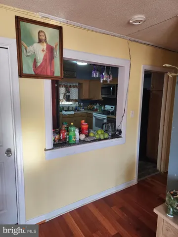 an empty room with wooden floor and painting on the wall