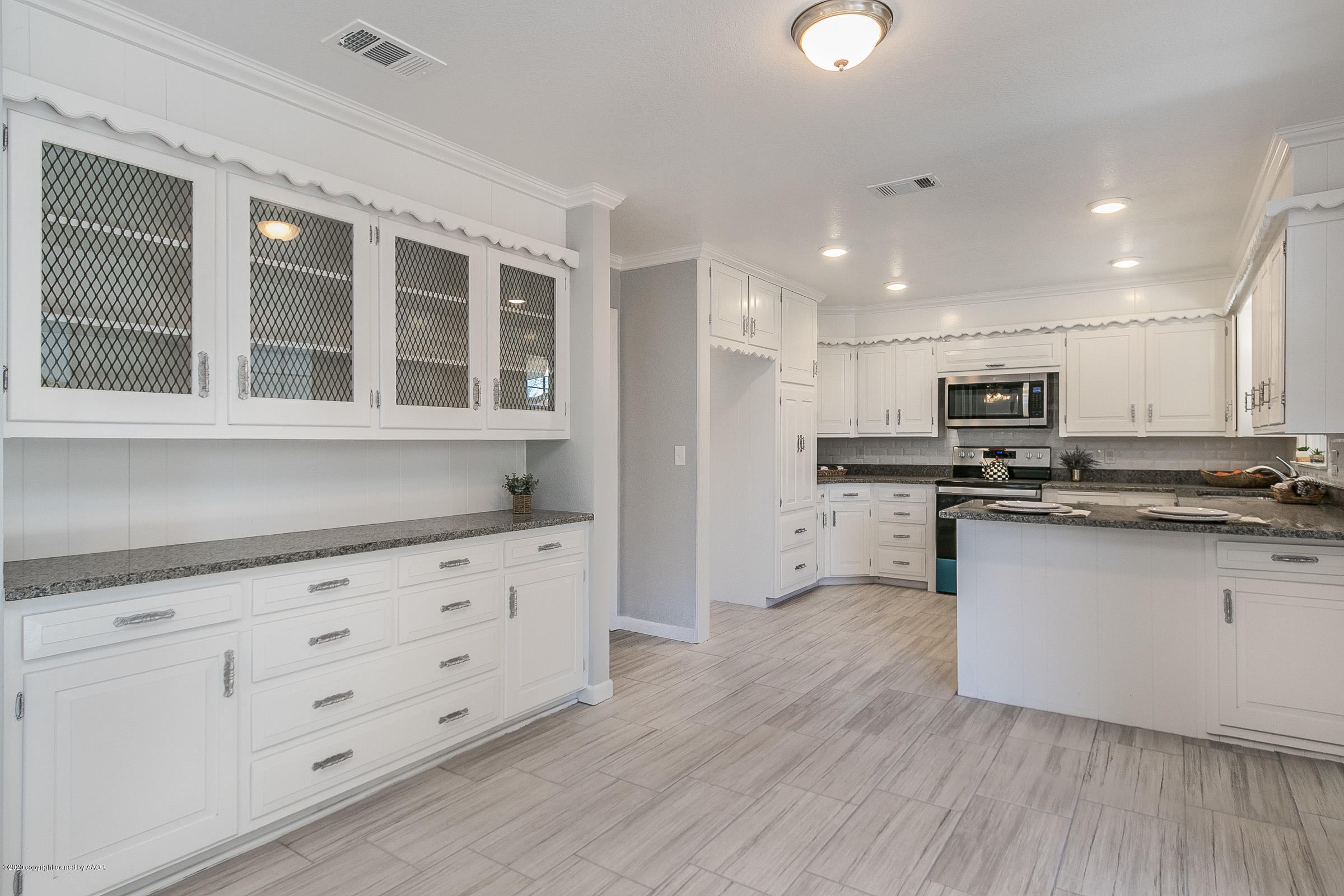 6113 Gainsborough Road Amarillo, TX 79106 - Photo 8 of 26 a kitchen with granite countertop white cabinets and stainless steel appliances