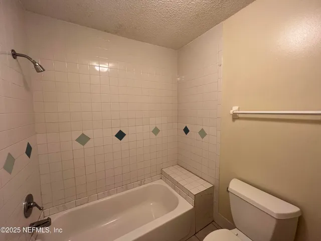 a bathroom with a bathtub and shower