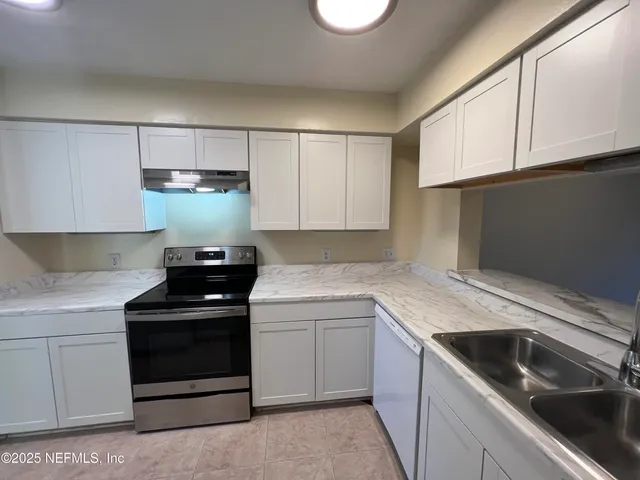 a kitchen with a refrigerator sink and stove