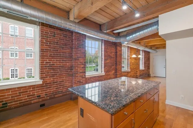 a bathroom with a granite countertop sink and large mirror