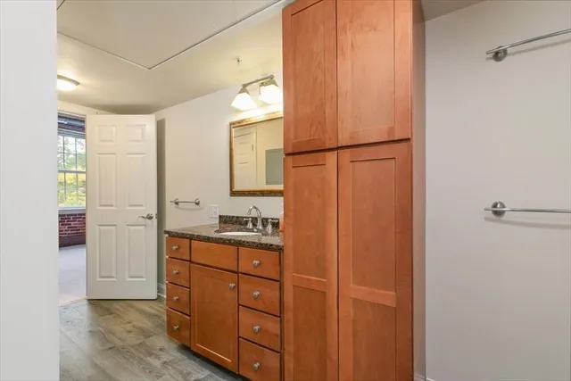 a bathroom with a granite countertop sink and a mirror