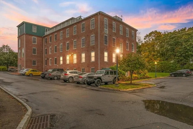 a view of building with parked cars