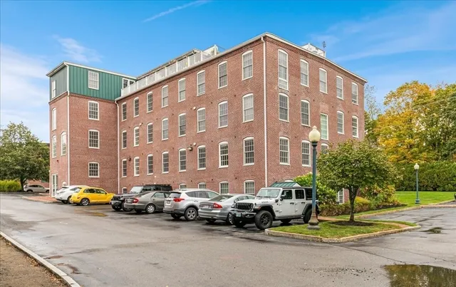 a view of a wooden deck with a barbeque grill and floor to ceiling window