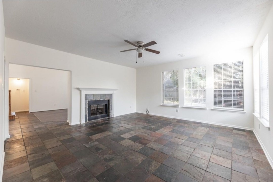 2515 Falcon Ridge Street Pearland, TX 77584 - Photo 11 of 31 a view of an empty room with a fireplace and a window